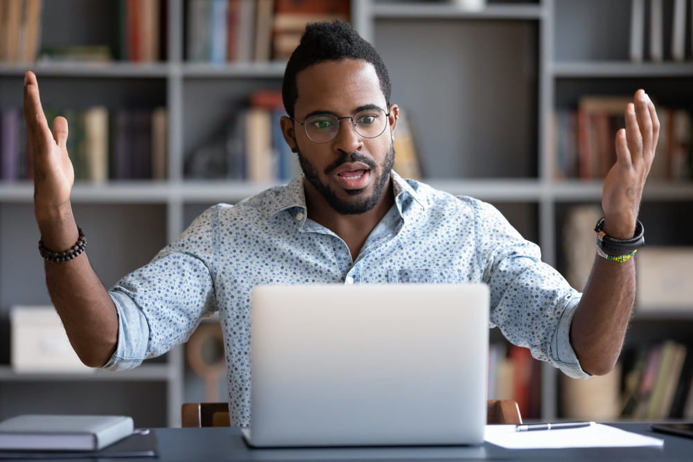 Stressed guy sitting in front of computer